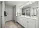 Bright bathroom featuring double sink vanity, tile floors, and ample counter space at 16564 Silversaw Palm Dr, Winter Garden, FL 34787