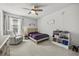 Well-lit bedroom featuring a comfortable chair, neutral colors, and plush carpeting throughout at 16564 Silversaw Palm Dr, Winter Garden, FL 34787