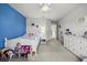 Bright bedroom featuring a blue accent wall, white trim, and plush carpeting throughout at 16564 Silversaw Palm Dr, Winter Garden, FL 34787