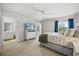 Neutral bedroom with a large window, TV, and ensuite bathroom at 16564 Silversaw Palm Dr, Winter Garden, FL 34787
