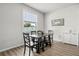 Sunlit dining room with dark wood table and chairs, offering a simple yet elegant space at 16564 Silversaw Palm Dr, Winter Garden, FL 34787