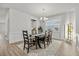 Formal dining room featuring a modern chandelier, wooden table and chairs, and lots of natural light at 16564 Silversaw Palm Dr, Winter Garden, FL 34787