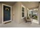 Welcoming front porch with cozy seating, a decorated entrance door, and lots of natural light at 16564 Silversaw Palm Dr, Winter Garden, FL 34787
