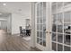 Hallway leading to dining room, kitchen and office with glass french doors at 16564 Silversaw Palm Dr, Winter Garden, FL 34787