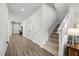 Entry hallway with staircase, neutral walls, wood-look flooring, leading to the home's living spaces at 16564 Silversaw Palm Dr, Winter Garden, FL 34787