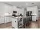 Spacious kitchen with white cabinets, granite countertops, stainless steel appliances, and a large island at 16564 Silversaw Palm Dr, Winter Garden, FL 34787