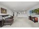 Spacious living room with plush seating, large tv, neutral walls and flooring, offering great space at 16564 Silversaw Palm Dr, Winter Garden, FL 34787