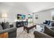 Comfortable living room with plush sofas, a large TV, and sliding glass doors for natural light at 16564 Silversaw Palm Dr, Winter Garden, FL 34787