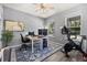 Bright office features desk, computer, exercise bike, and a ceiling fan to keep the room cool at 16564 Silversaw Palm Dr, Winter Garden, FL 34787