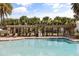 Community pool featuring lush landscaping and lounge chairs at 16564 Silversaw Palm Dr, Winter Garden, FL 34787