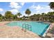Community pool featuring palm trees and ample seating at 16564 Silversaw Palm Dr, Winter Garden, FL 34787