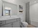 Well-lit bathroom with modern fixtures, a stylish vanity, and a shower/tub combo with decorative shower curtain at 2042 Education St, St Cloud, FL 34771