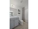 Well-lit bathroom with modern fixtures, a stylish vanity, and a shower/tub combo with decorative shower curtain at 2042 Education St, St Cloud, FL 34771