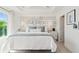 A beautifully staged bedroom features a decorative headboard, lamps, and neutral bedding at 2042 Education St, St Cloud, FL 34771