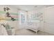Bright Bedroom with turtle wall decor, soft lighting, and large windows at 2042 Education St, St Cloud, FL 34771