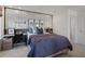 Well-lit bedroom with a decorative headboard, contemporary furnishings, and a dedicated workspace at 2042 Education St, St Cloud, FL 34771