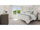 Bright and airy bedroom with a large window offering scenic views of lush greenery at 2042 Education St, St Cloud, FL 34771