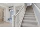 Bright entryway featuring a staircase, built-in storage, and access to the downstairs bathroom at 2042 Education St, St Cloud, FL 34771