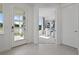 Bright foyer with a view into the home office that has neutral decor and lots of natural light at 2042 Education St, St Cloud, FL 34771