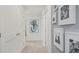 Neutral hallway with modern art and white doors at 2042 Education St, St Cloud, FL 34771
