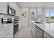 Contemporary kitchen with stainless appliances, marble backsplash, and abundant natural light at 2042 Education St, St Cloud, FL 34771