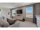 Cozy living room featuring comfortable seating, modern decor, and plenty of natural light from the large windows at 2042 Education St, St Cloud, FL 34771