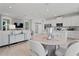 Bright open-concept living room with modern decor, wood floors, and a seamless flow to the kitchen at 2042 Education St, St Cloud, FL 34771