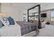 Inviting primary bedroom adjacent to living room with comfortable furnishings and neutral color palette at 2042 Education St, St Cloud, FL 34771