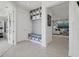 Well-organized mudroom with built-in shelving, bench seating, and stylish decor at 2042 Education St, St Cloud, FL 34771