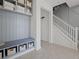 Stylish mudroom area featuring built-in shelving, bench seating, and convenient access to the staircase at 2042 Education St, St Cloud, FL 34771