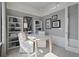 Stylish home office featuring modern wallpaper, built-in shelving, and a sleek white desk at 2042 Education St, St Cloud, FL 34771