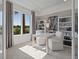 Bright and airy home office space with large windows, shelving, and neutral tones at 2042 Education St, St Cloud, FL 34771