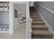 Inviting foyer with a carpeted staircase and view into the adjacent living area at 2042 Education St, St Cloud, FL 34771