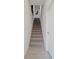 Staircase with carpeted steps and white walls, complemented by tile flooring at the base at 2042 Education St, St Cloud, FL 34771