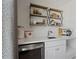 Upstairs wet bar area, with stainless steel refrigerator, and floating shelves at 2042 Education St, St Cloud, FL 34771