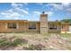 View of backyard with neutral color exterior, chimney, windows and privacy fence at 2078 Keyes Ln, Deltona, FL 32738