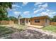 Exterior view of home featuring a wood deck, fenced yard, and mature trees at 2078 Keyes Ln, Deltona, FL 32738