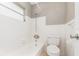 A bright bathroom shows white subway tiles in shower and toilet, window and tile flooring at 2078 Keyes Ln, Deltona, FL 32738