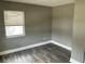 Comfortable bedroom with natural light, wood-look flooring, and neutral tones, ready for your personal touch at 2078 Keyes Ln, Deltona, FL 32738