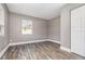 Bedroom offers plank flooring, neutral colored walls, a large closet, and a bright, sunny window at 2078 Keyes Ln, Deltona, FL 32738