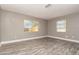 Spacious bedroom with two windows providing natural light and wood-look flooring at 2078 Keyes Ln, Deltona, FL 32738
