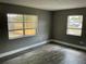 Bedroom features wood-look flooring and two windows for ample natural light at 2078 Keyes Ln, Deltona, FL 32738