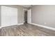 A bedroom features plank flooring, neutral colored walls, a closet, a full length mirror and entry doorway at 2078 Keyes Ln, Deltona, FL 32738