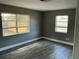 Bedroom with wood floors and natural light from two windows overlooking the fenced backyard at 2078 Keyes Ln, Deltona, FL 32738