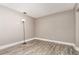 An empty bedroom featuring wood-look floors, neutral-colored walls, and a standing lamp at 2078 Keyes Ln, Deltona, FL 32738