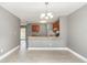 Open concept dining area and kitchen featuring a breakfast bar and wood cabinets at 2078 Keyes Ln, Deltona, FL 32738