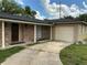 Charming single-story home with brick accents, a driveway, and a one-car garage at 2078 Keyes Ln, Deltona, FL 32738