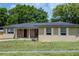 Charming single-story home with tan exterior, brick accents, and a well-manicured front yard at 2078 Keyes Ln, Deltona, FL 32738