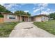 Single story home with brick detail, stucco exterior, and long driveway at 2078 Keyes Ln, Deltona, FL 32738