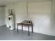 Spacious garage featuring a water heater and a table with paint cans for home improvement projects at 2078 Keyes Ln, Deltona, FL 32738